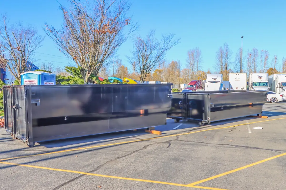 Professional dumpster rental service with roll-off container on residential driveway in Hood River